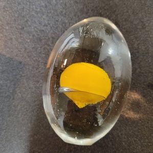 Egg shaped paperweight with yolk